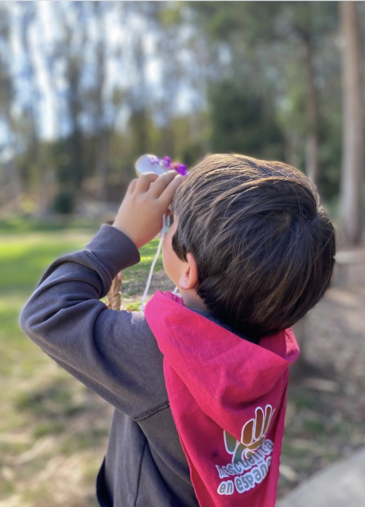 Program Kid looking at the sky with binoculars